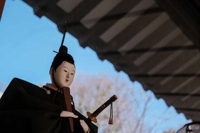 Low angle view of man standing against sky