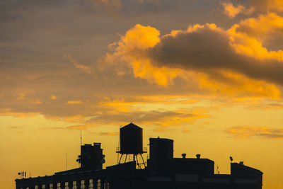 Low angle view of building against orange sky