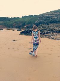 Full length of woman standing on landscape