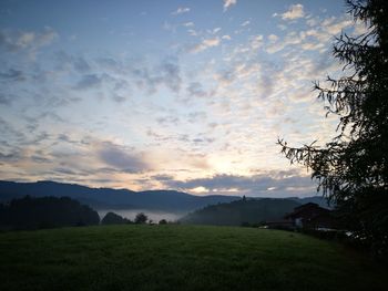 Scenic view of field against sky during sunset