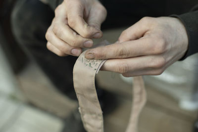 Cropped image of man holding wedding rings