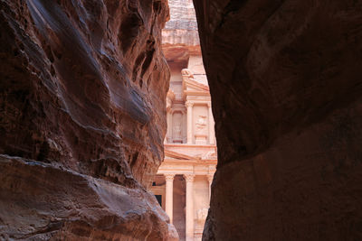 Rock formations against ancient building 