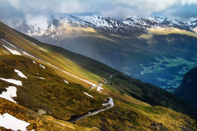 Scenic view of snowcapped mountain against cloudy sky