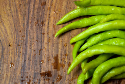 High angle view of green chili peppers on table