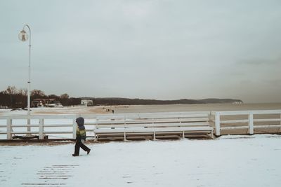 Full length of man on snow covered land against sky