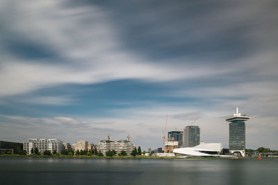 Buildings in city against cloudy sky amsterdam skyline long exposure eye museum