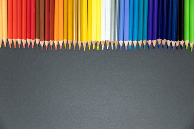 Close-up of colored pencils against white background