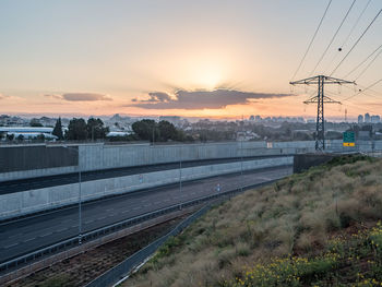 Railroad tracks against sky during sunset