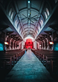 Empty corridor in illuminated building