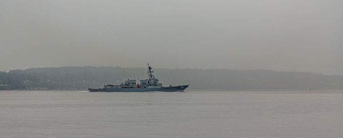 Ship sailing in sea against sky