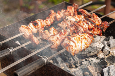 Marinated shashlik preparing on barbecue grill over charcoal. shish kebab popular in eastern europe