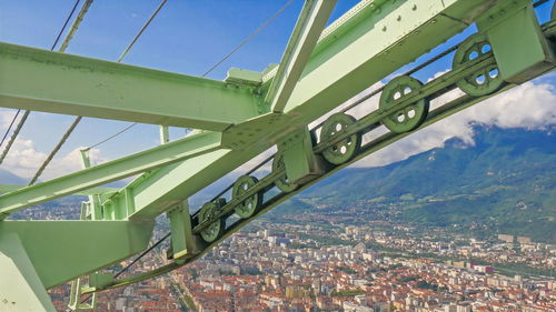 Low angle view of bridge and buildings against sky