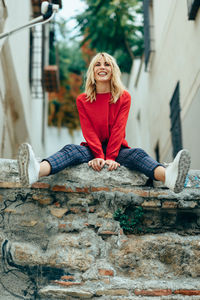 Portrait of young woman sitting outdoors