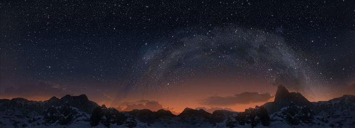 Scenic view of mountains against sky at night