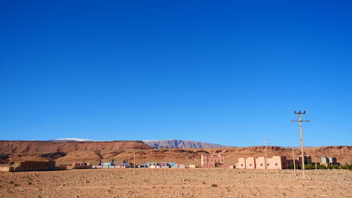 Scenic view of desert against clear blue sky