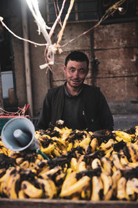 High angle view of young man holding fish for sale