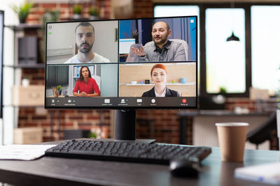 Portrait of businessman talking on video call at office