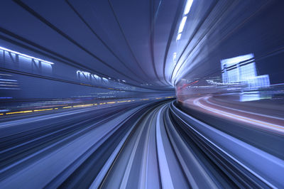 Light trails on railroad tracks in city