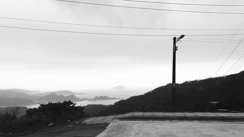 Road by mountain against sky