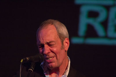 Portrait of man with eyes closed at night