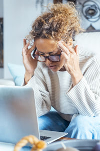 Young woman using laptop at home