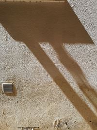 High angle view of shadow on wall of building