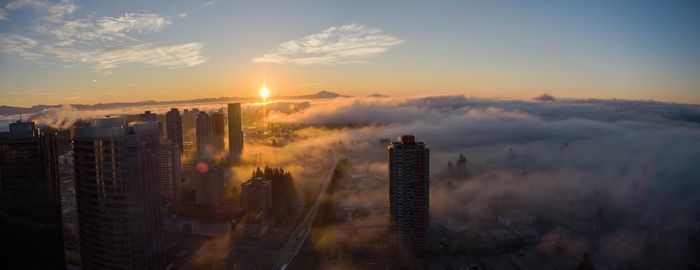 Panoramic view of modern buildings against sky during sunset