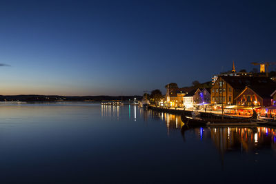 Night shot of northern sea with port and sunset, blue skies and water, calm sea.