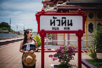 Woman with text on wall outdoors