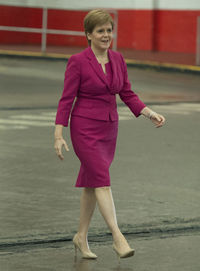 Full length of a smiling girl standing outdoors