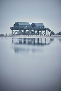 Pier over sea against clear sky