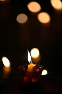 Lit tea light candles in dark room