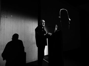 Man and woman standing against wall