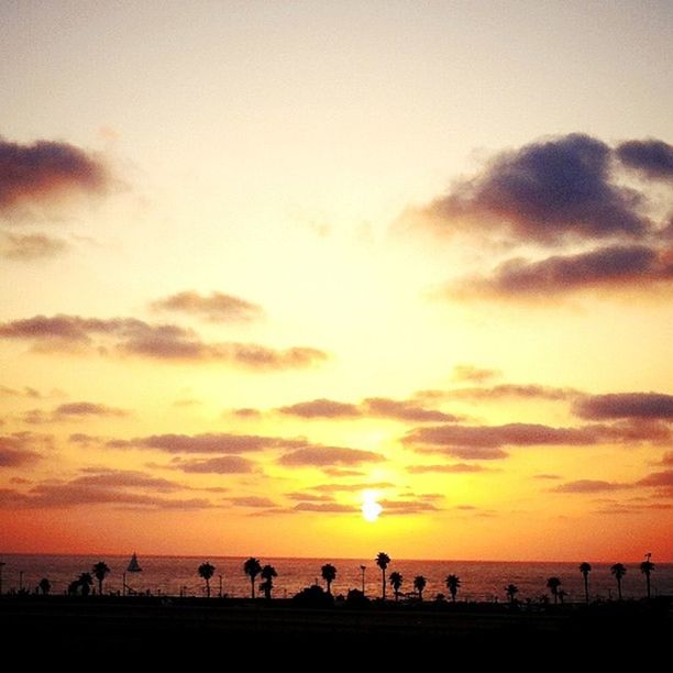 TOURISTS ON BEACH AT SUNSET