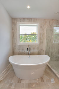 Soaking bathtub with a view has been installed on new ceramic tiles 