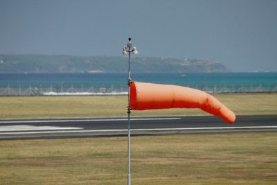 Close-up of rope hanging over sea against sky