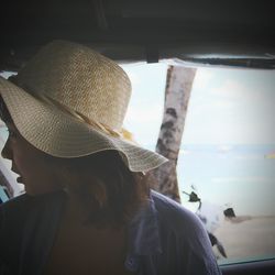 Close-up of woman wearing hat against sky