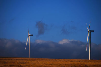 Windmill on field against sky