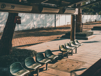 Empty chairs and tables in row