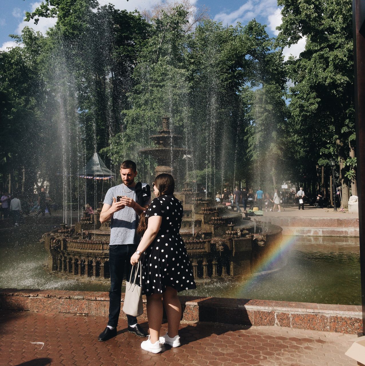 tree, full length, women, two people, men, togetherness, water, fountain, plant, real people, standing, young adult, adult, day, nature, males, architecture, people, females, outdoors, positive emotion, couple - relationship