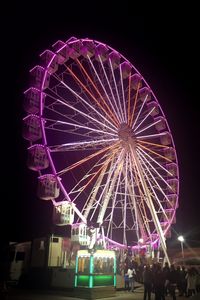 Low angle view of ferris wheel at night