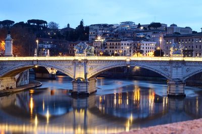 Illuminated bridge over river