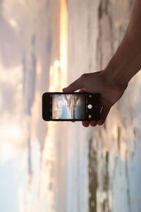 Cropped image of man holding camera