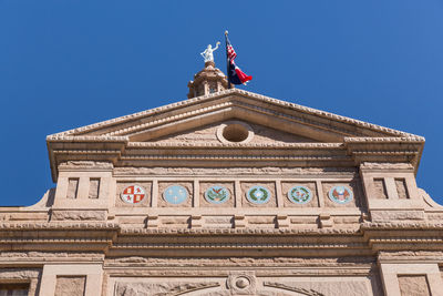 Low angle view of building against blue sky