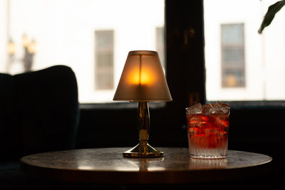 Close-up of illuminated lamp on table in restaurant