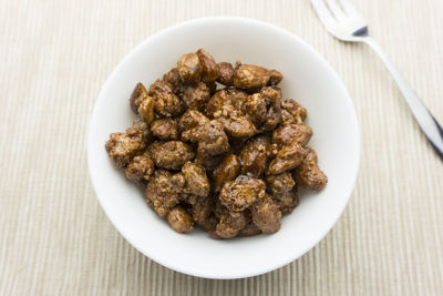 High angle view of roasted almonds in bowl on table