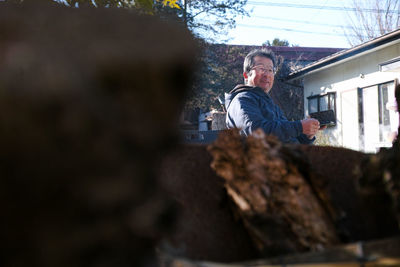 Side view of man looking at tree