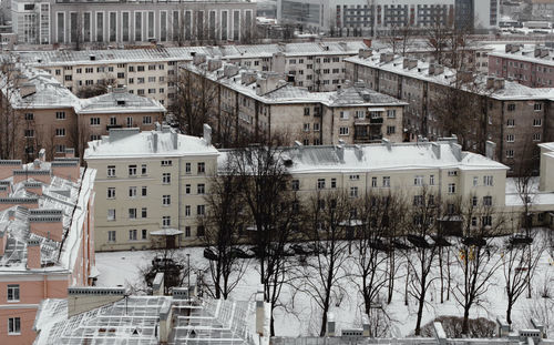 High angle view of snow covered buildings in city