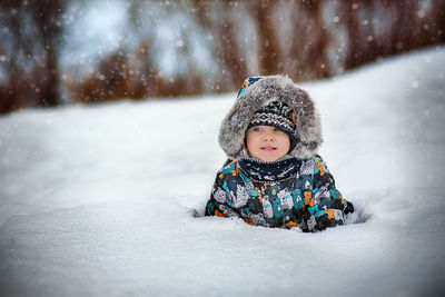 Portrait of smiling young woman skiing on snow