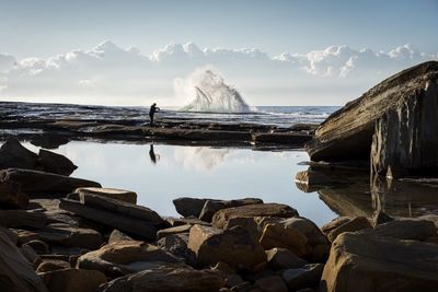 Waves flowing at sea against sky